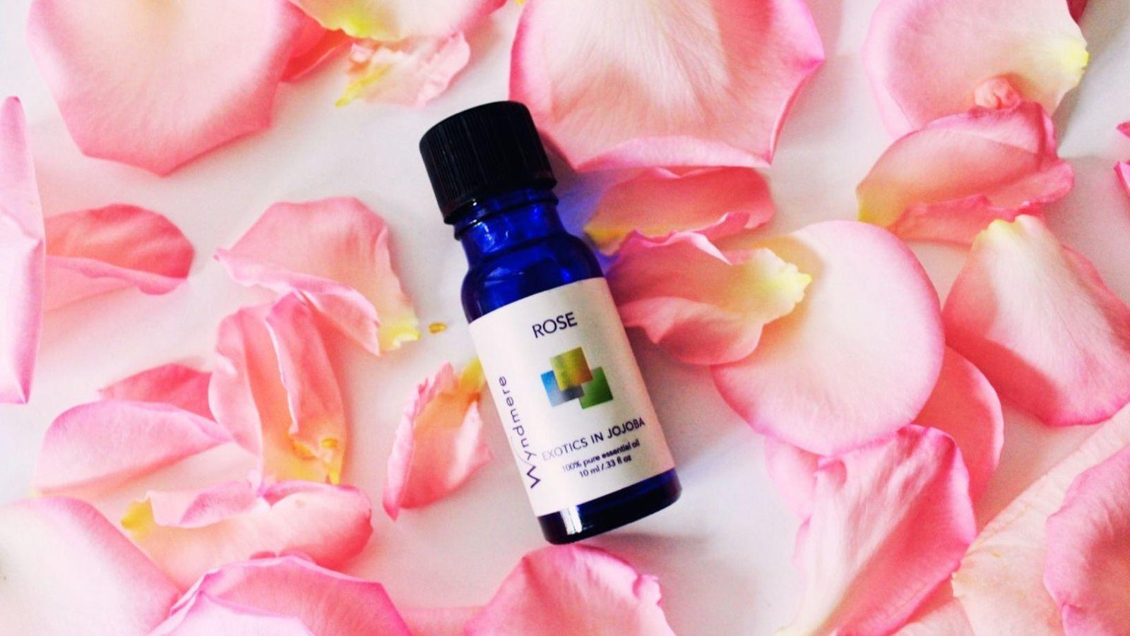 Rose in jojoba 10ml bottle on a bed of rose petals - Wyndmere Naturals