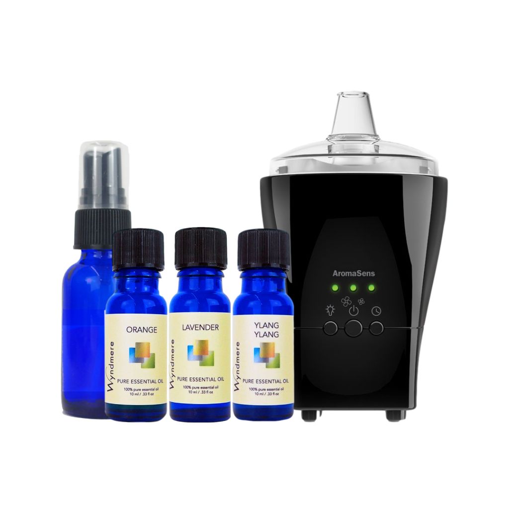 Orange, Lavender, and Ylang Ylang essential oils, and a glass cobalt blue spray bottle, AromaSens diffuser on a white background..