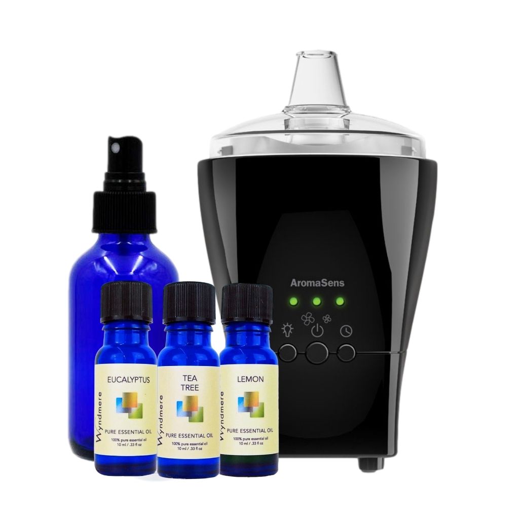 Black AromaSens diffuser with blue Wyndmere essential oil bottles on a white background