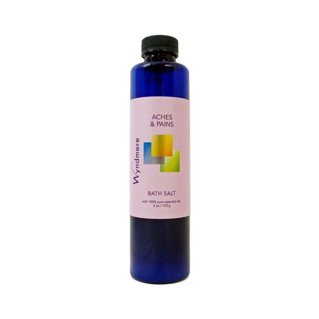 6 ounce cobalt blue bottle of Wyndmere Aches & Pains Bath Salt having the best essential oils for sore muscles
