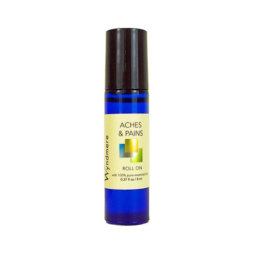 An 8ml cobalt blue roll-on bottle of Wyndmere Aches & Pains blend