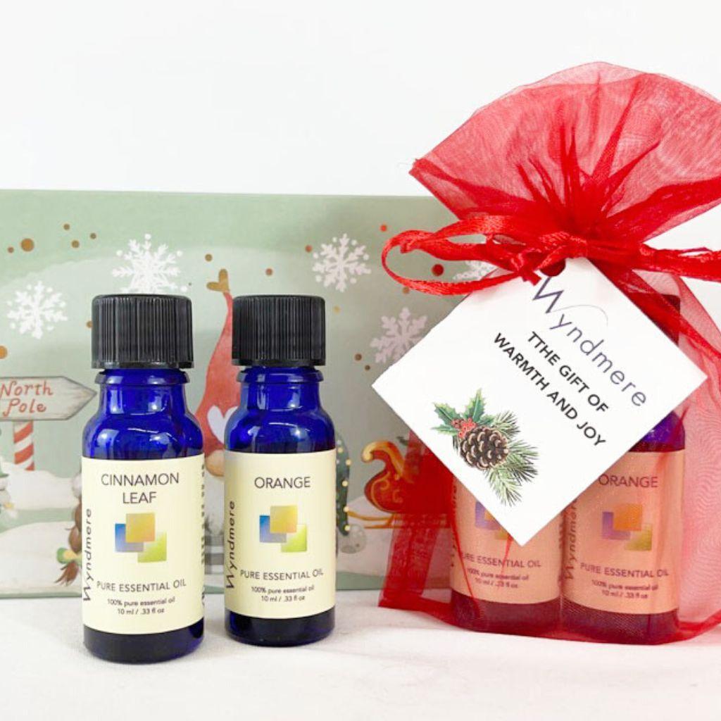 Wyndmere - holiday gifts cinnamon leaf and orange essential oils in red organza bag.