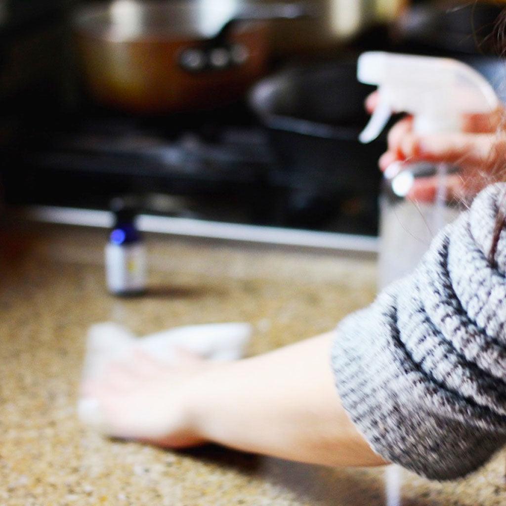 Woman spraying countertop