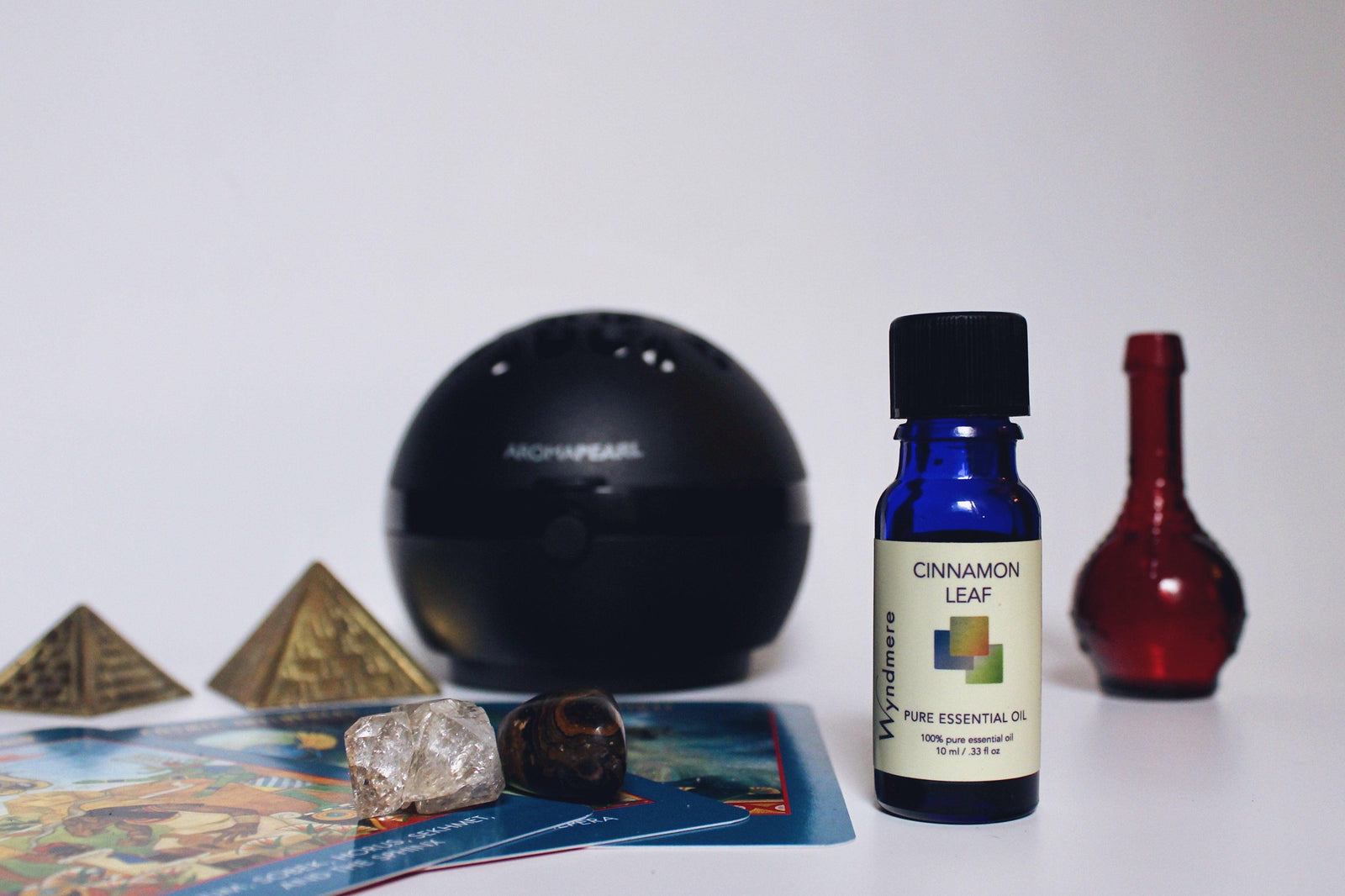 Bottle of Cinnamon Leaf essential oil with black AromaPearl