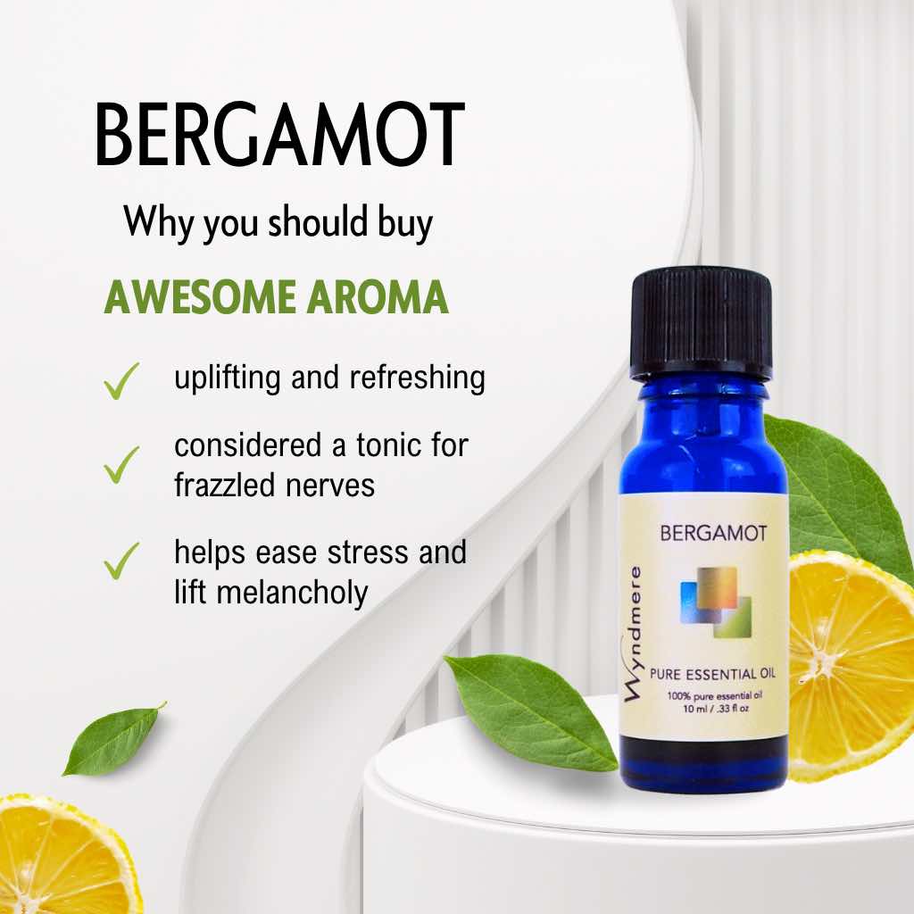 Bergamot essential oil bottle with lemon slices and leaves on a white background