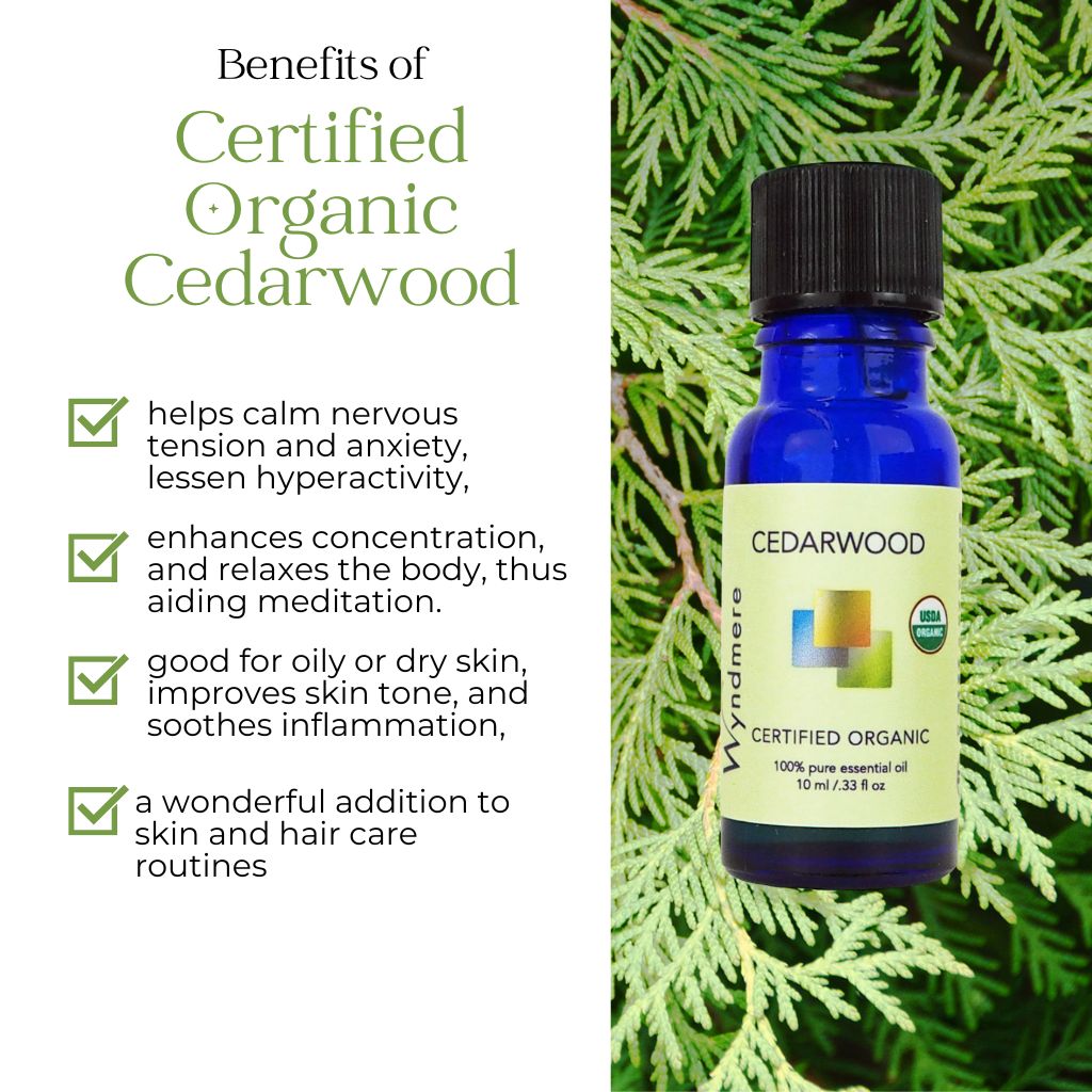 Wyndmere certified organic Cedarwood essential oil bottle with benefits listed on a green leafy background
