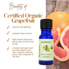 Wyndmere certified organic Grapefruit essential oil bottle on a wooden table with grapefruit slices