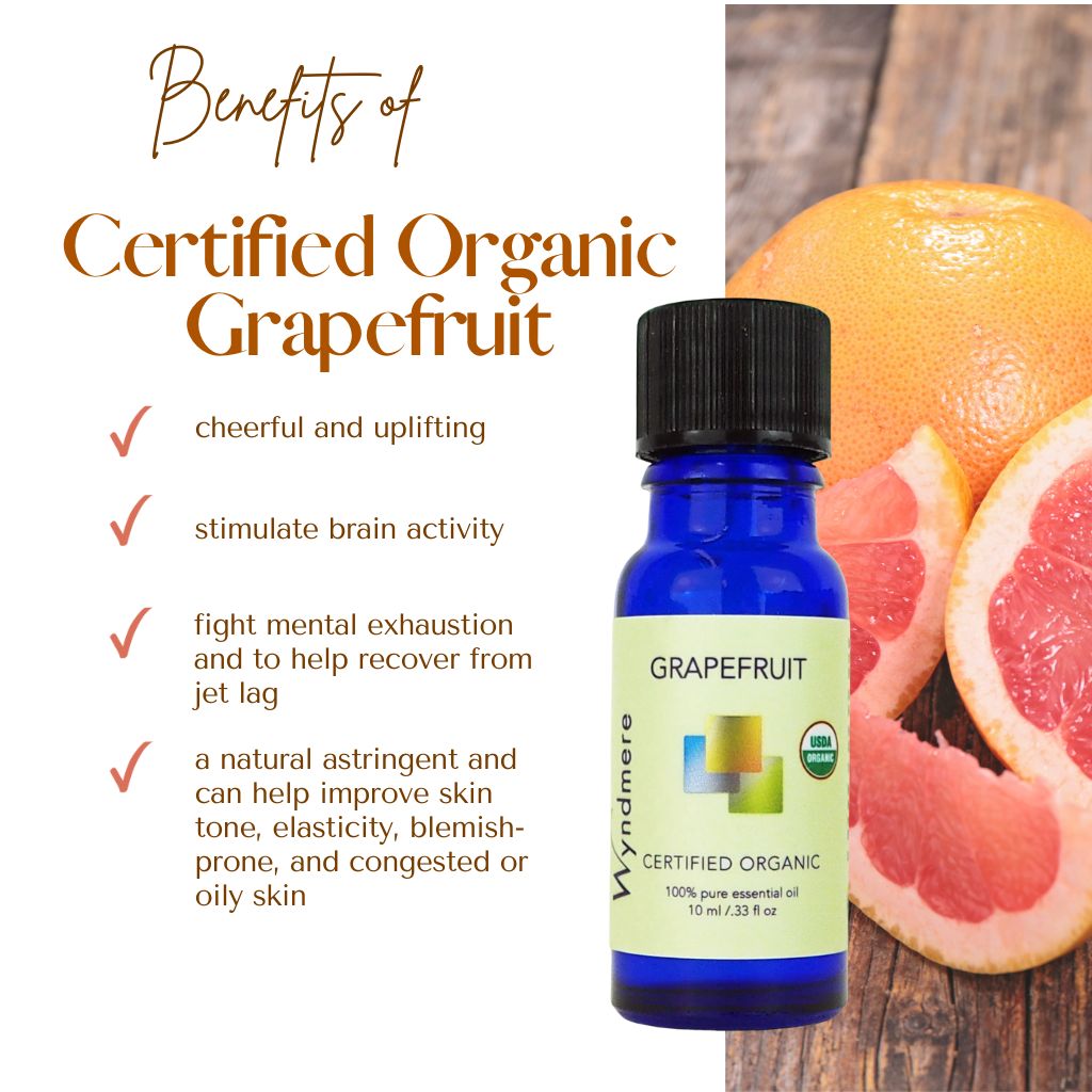 Wyndmere certified organic Grapefruit essential oil bottle on wooden table with grapefruit slices and with benefits listed on a white background