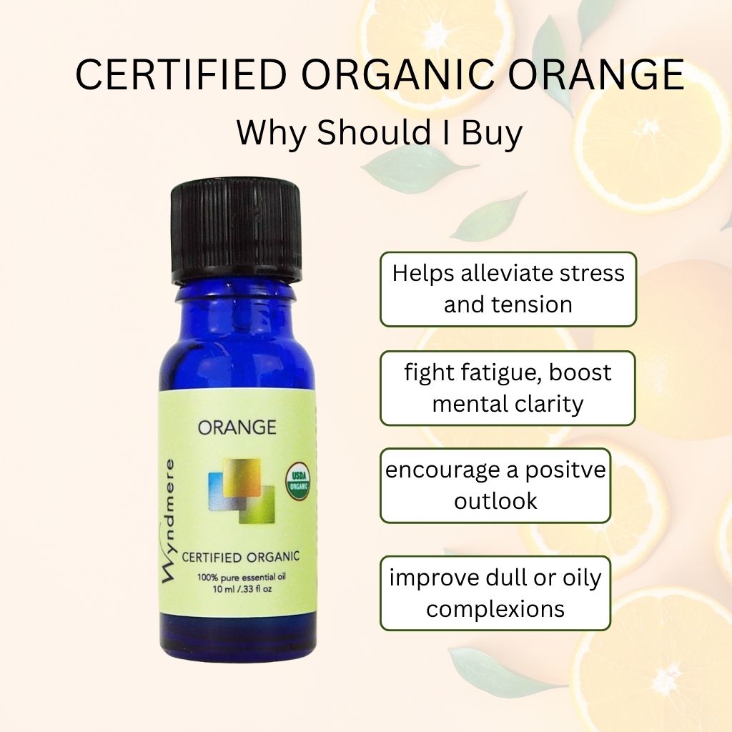Wyndmere certified organic Orange essential oil bottle with benefits text on a light background of oranges
