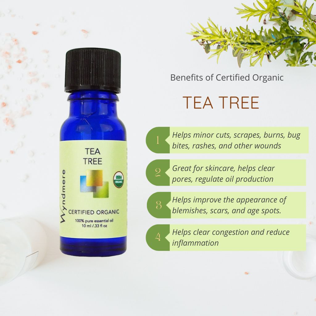 Bottle of certified organic tea tree oil with benefits listed on a light background