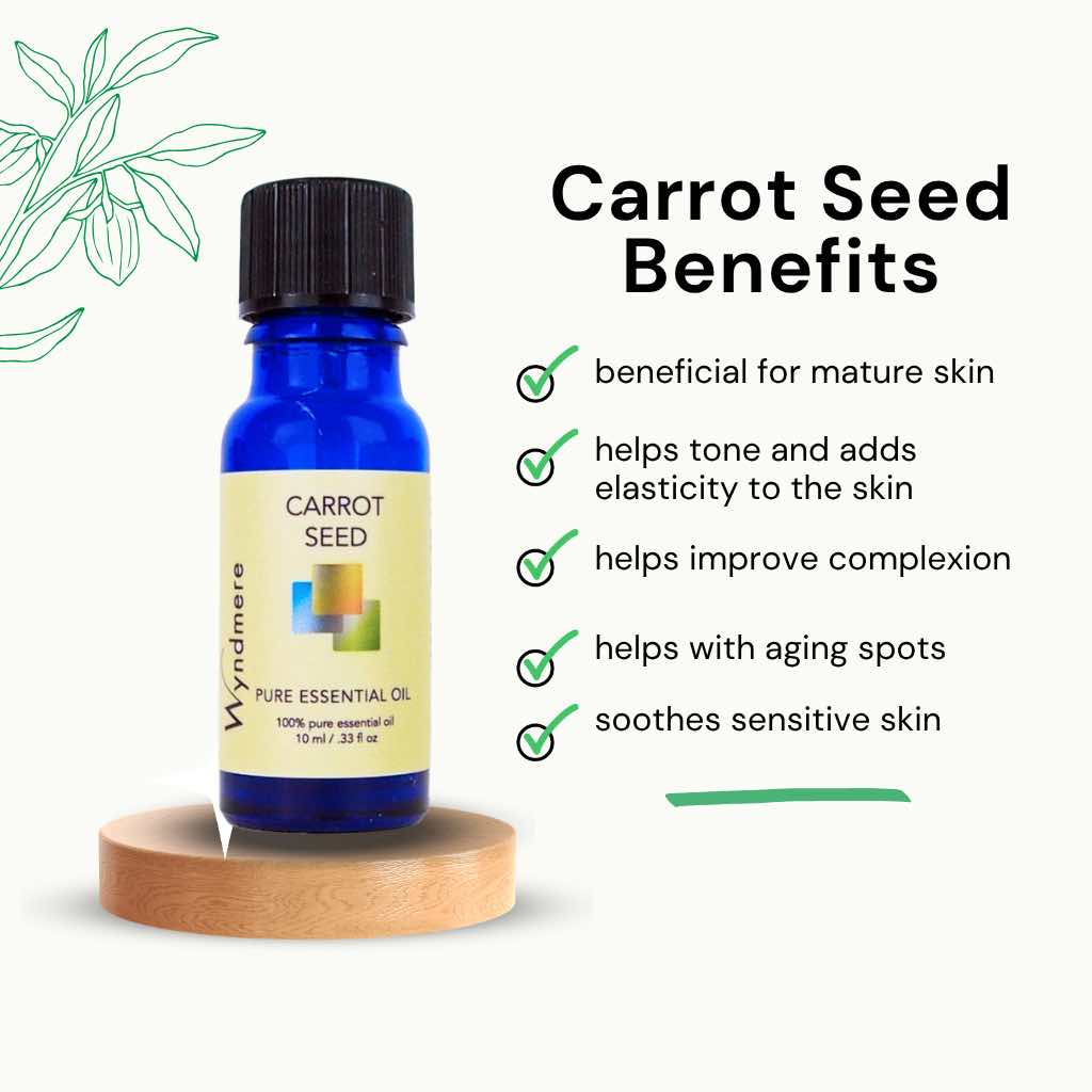 Carrot seed essential oil in a cobalt blue bottle with benefits listed on a white background