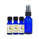 Orange, Lavender, and Ylang Ylang essential oils, and 1oz glass cobalt blue bottles on a white background.