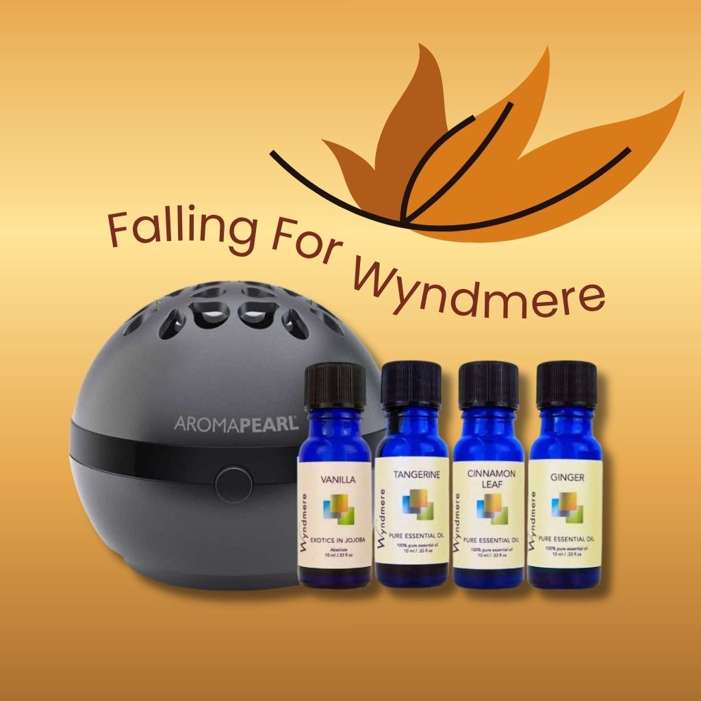 Aroma Pearl diffuser with Wyndmere essential oil bottles on a beige background