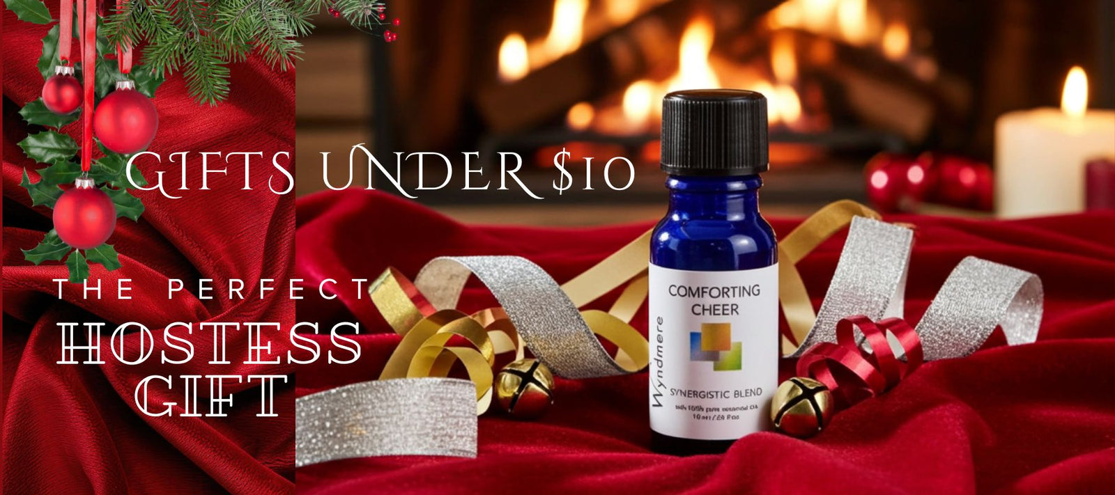 Bottle of 'Wyndmere Comforting Cheer' essential oil on a red fabric with Christmas decorations and text about gifts under $10.