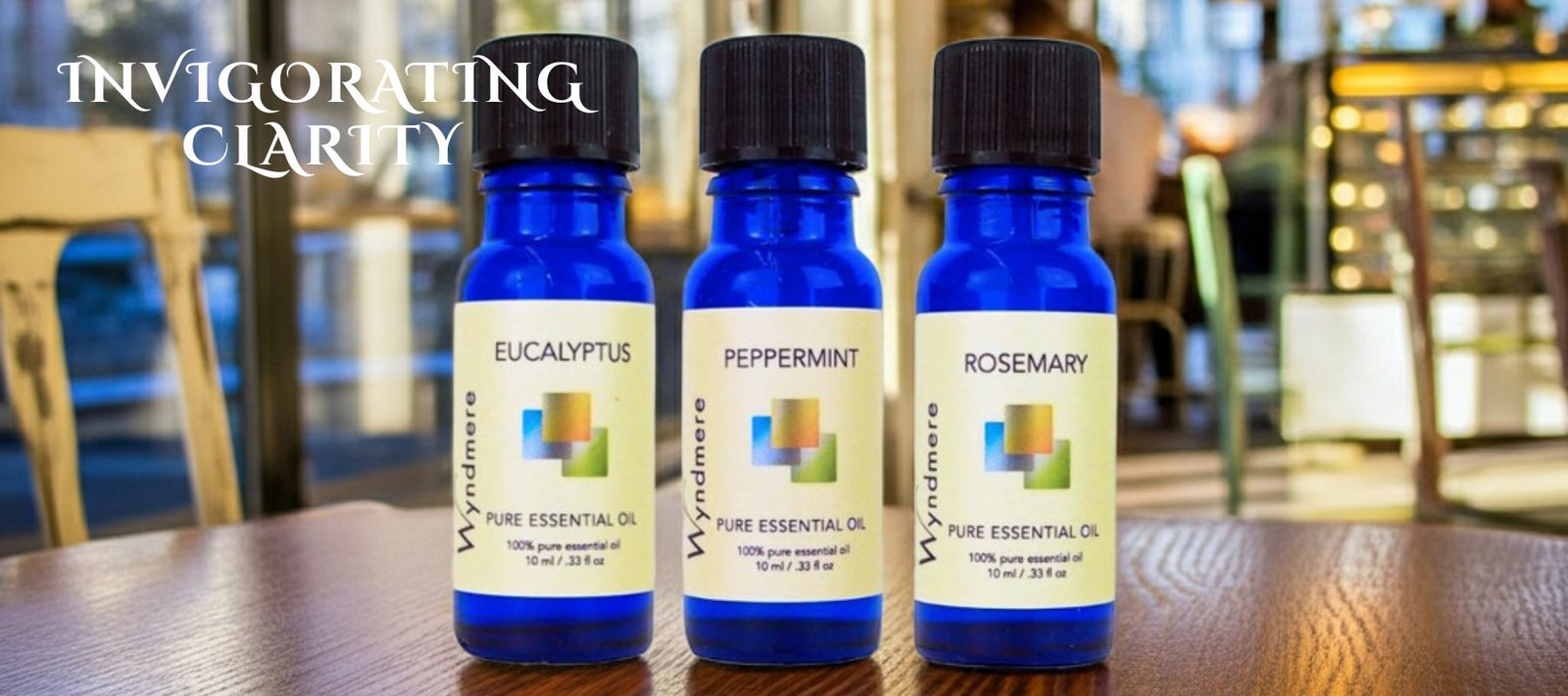 Three bottles of pure essential oils on a table with blurred background