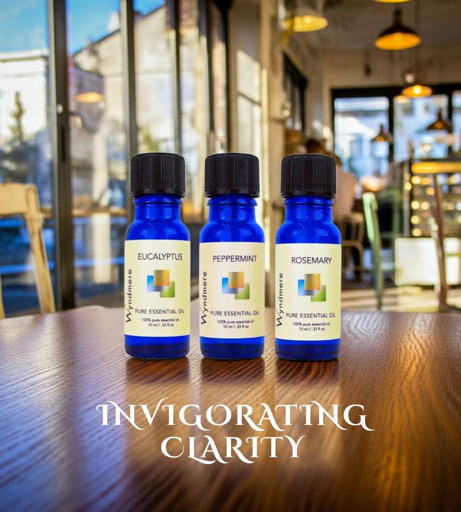 Three essential oil bottles labeled Eucalyptus, Peppermint, and Rosemary on a wooden table with a blurred restaurant background.