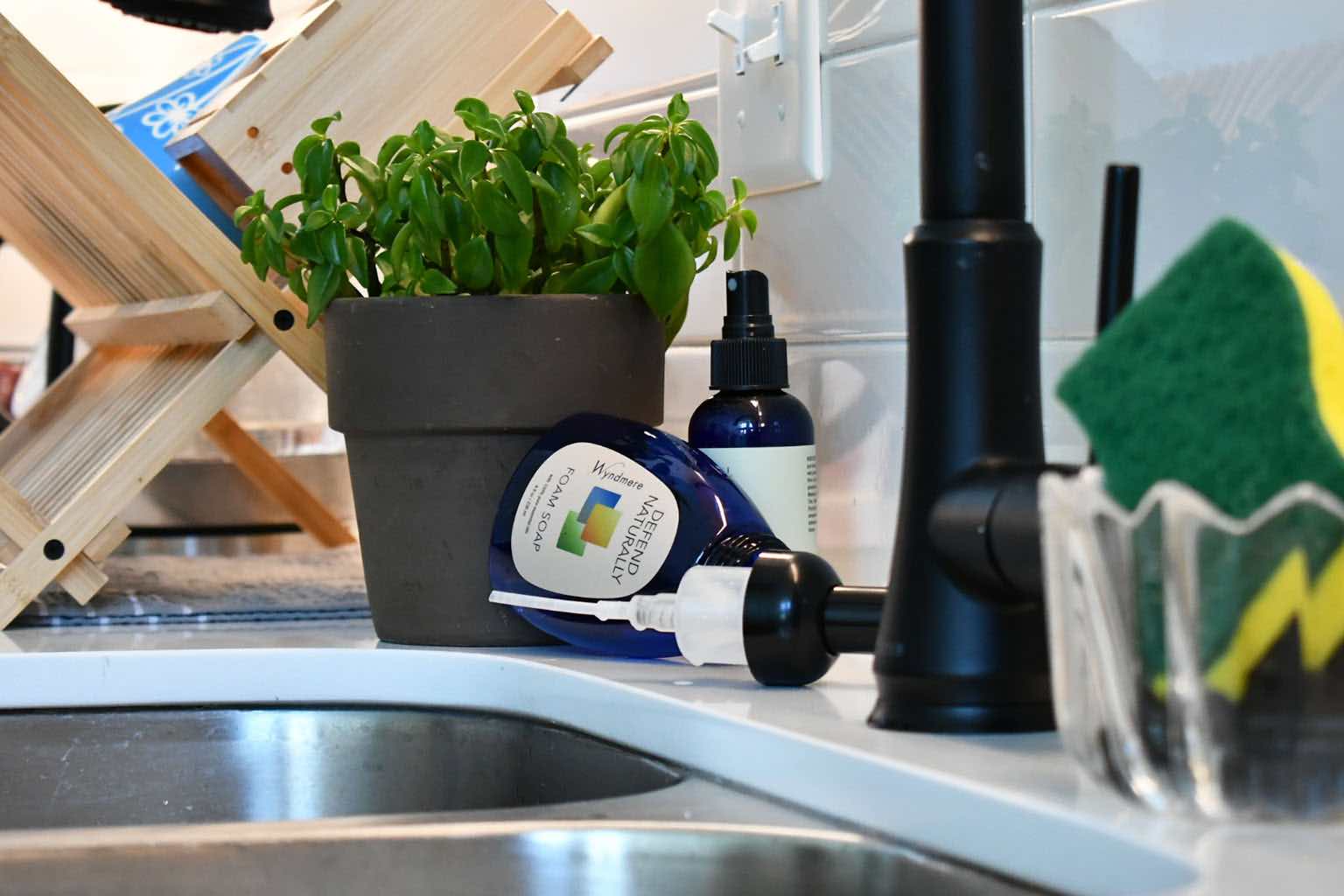 Empty bottle of Defend Naturally near a kitchen sink