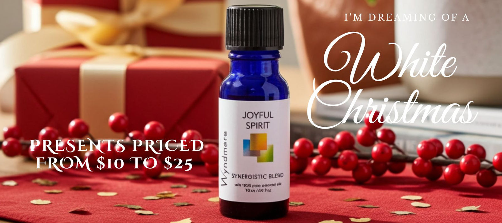 Bottle of 'Wyndmere Joyful Spirit' essential oil blend with Christmas decorations and text about gift prices.