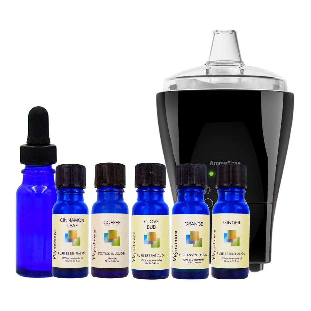 Set of blue essential oil bottles with labels and a black electronic device on a white background