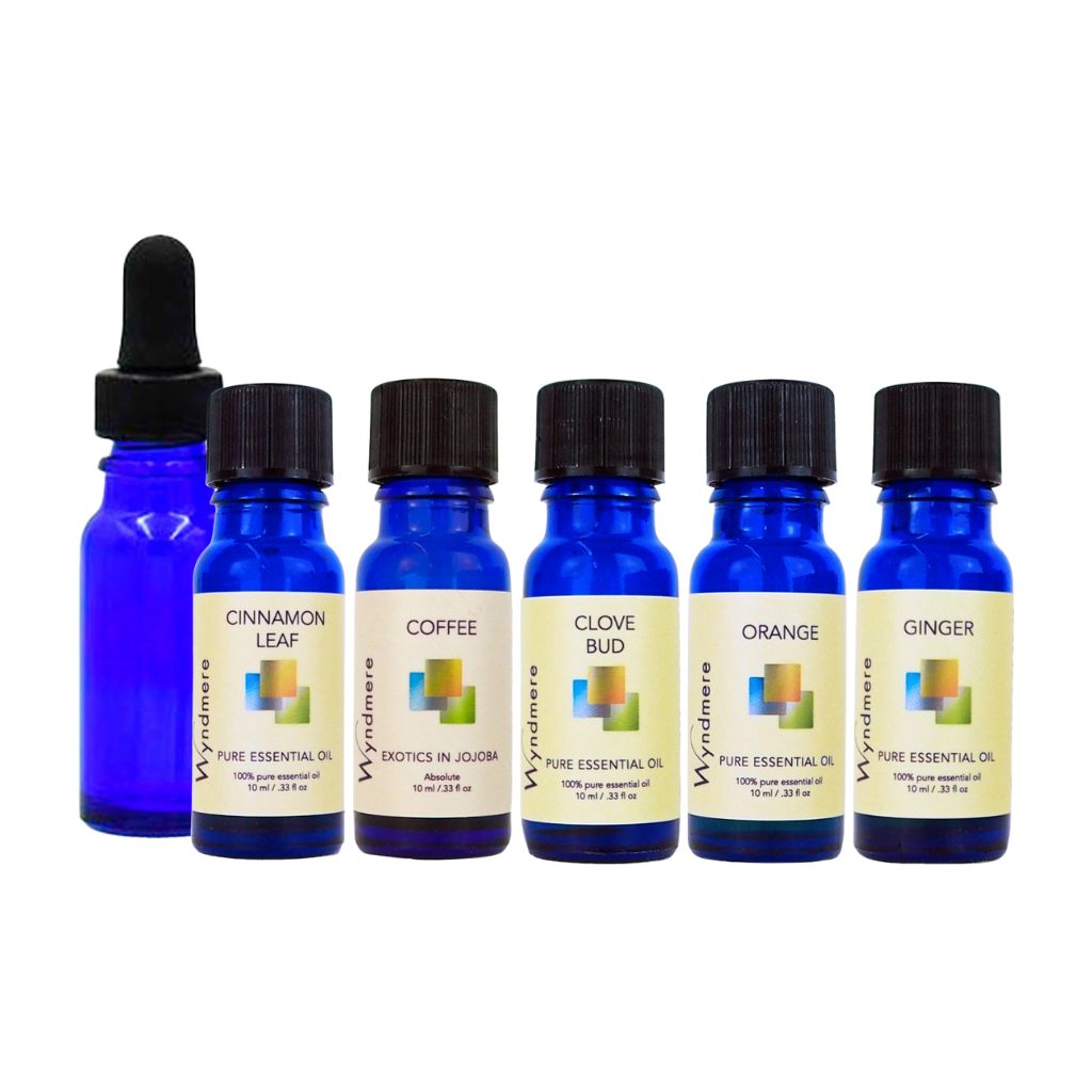 Set of blue essential oil bottles with yellow labels. The set includes a blue glass 1/2 oz dropper bottle, and an AromaSens diffuser on a white background - Wyndmere