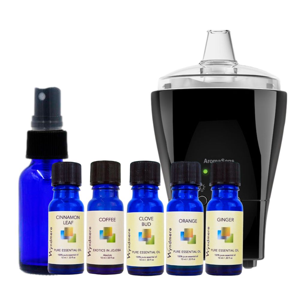 Set of blue essential oil bottles with labels and a black electronic device on a white background