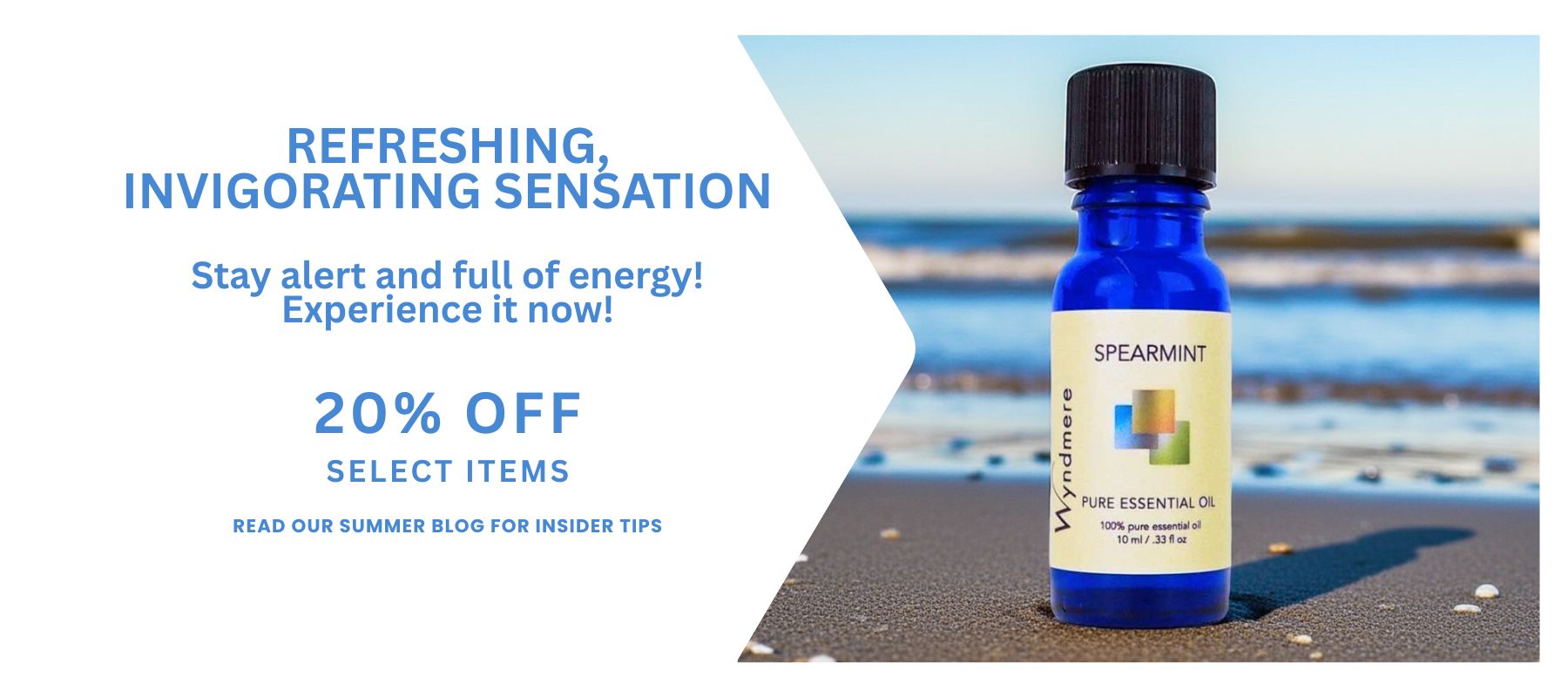 Wyndmere - Pictured is spearmint essential oil sitting on a sandy beach with waves in the background. 