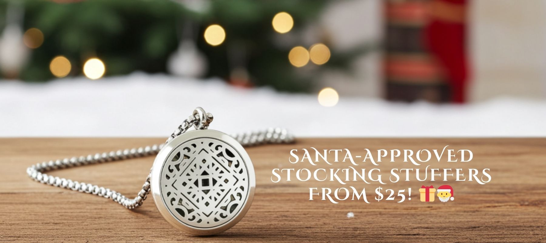 Wyndmere aromatherapy silver necklace with decorative pendant on a wooden surface, Christmas lights in the background