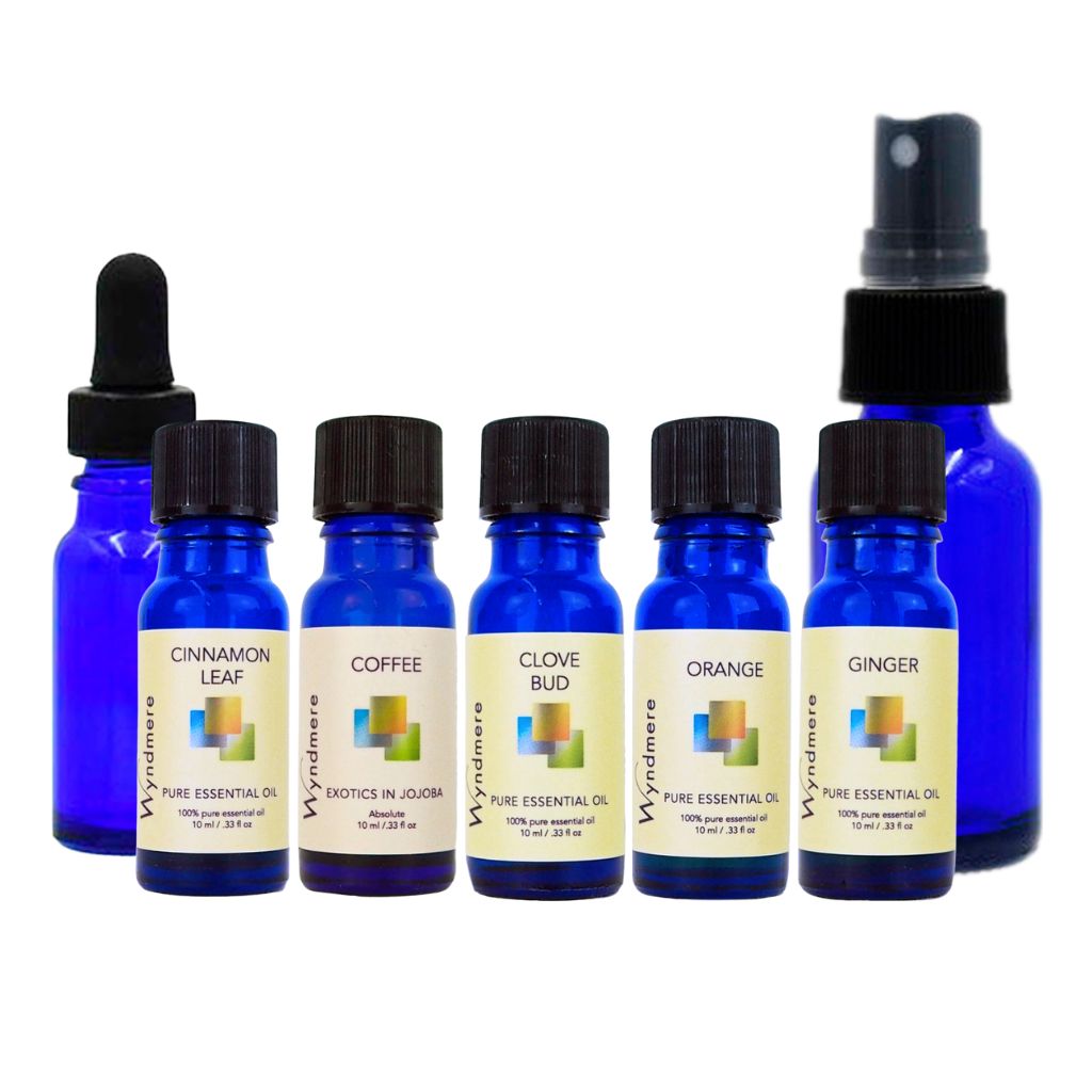 Set of blue essential oil bottles with labels on a white background