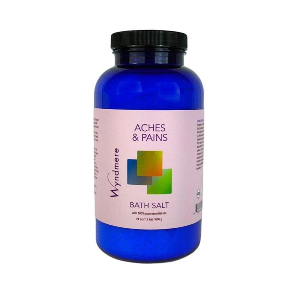 24 ounce cobalt blue bottle of Wyndmere Aches &amp; Pains Bath Salt having the best essential oils for sore muscles