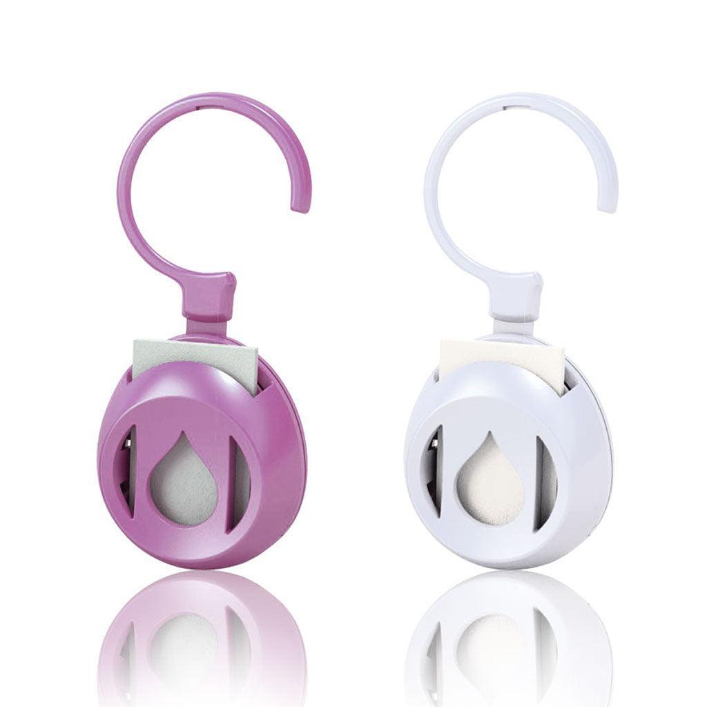 Purple and white AromaPod personal aromatherapy diffusers for diffusing essential oils on the go, at home or work.