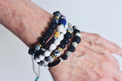 5 aromatherapy bracelets with lava stones on wrist