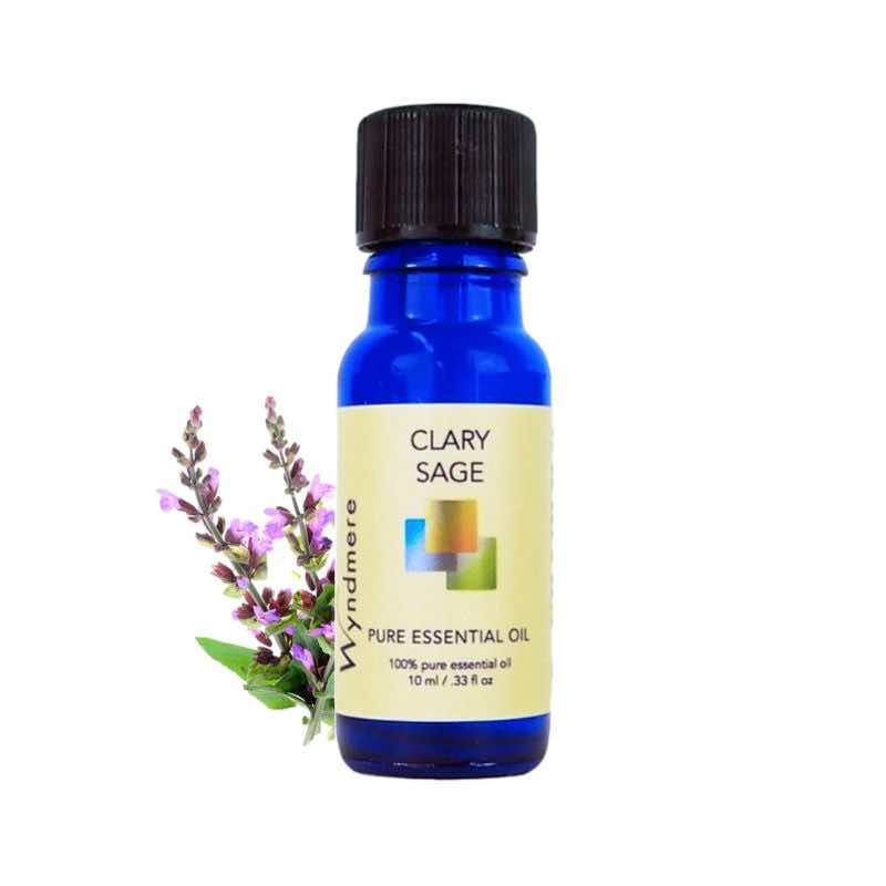Clary Sage flower tops with a 10ml cobalt blue bottle of Wyndmere Clary Sage Essential Oil