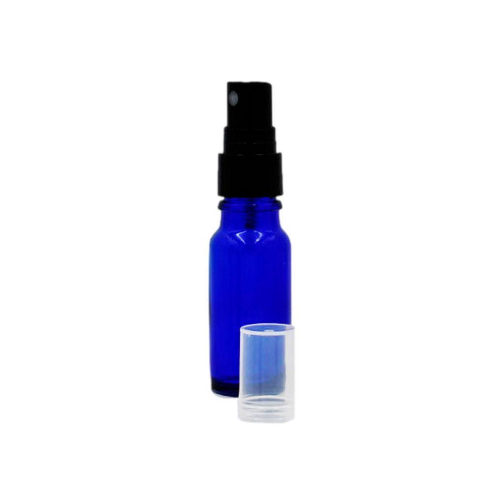 1/2 oz cobalt blue boston round glass bottle with black fine spray mister with clear hood off on the table by the bottle