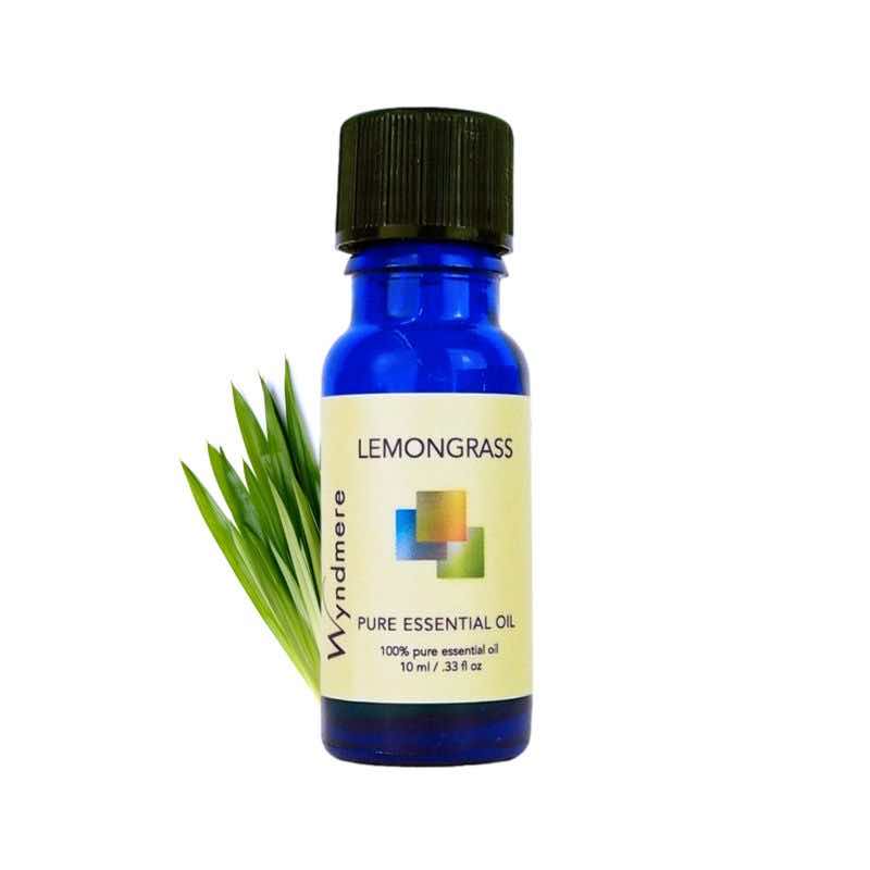 Lemongrass plant with a 10ml cobalt blue bottle of Wyndmere Lemongrass Essential Oil