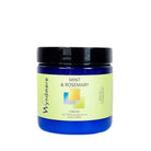 A 4oz cobalt blue jar of Wyndmere Mint & Rosemary cream