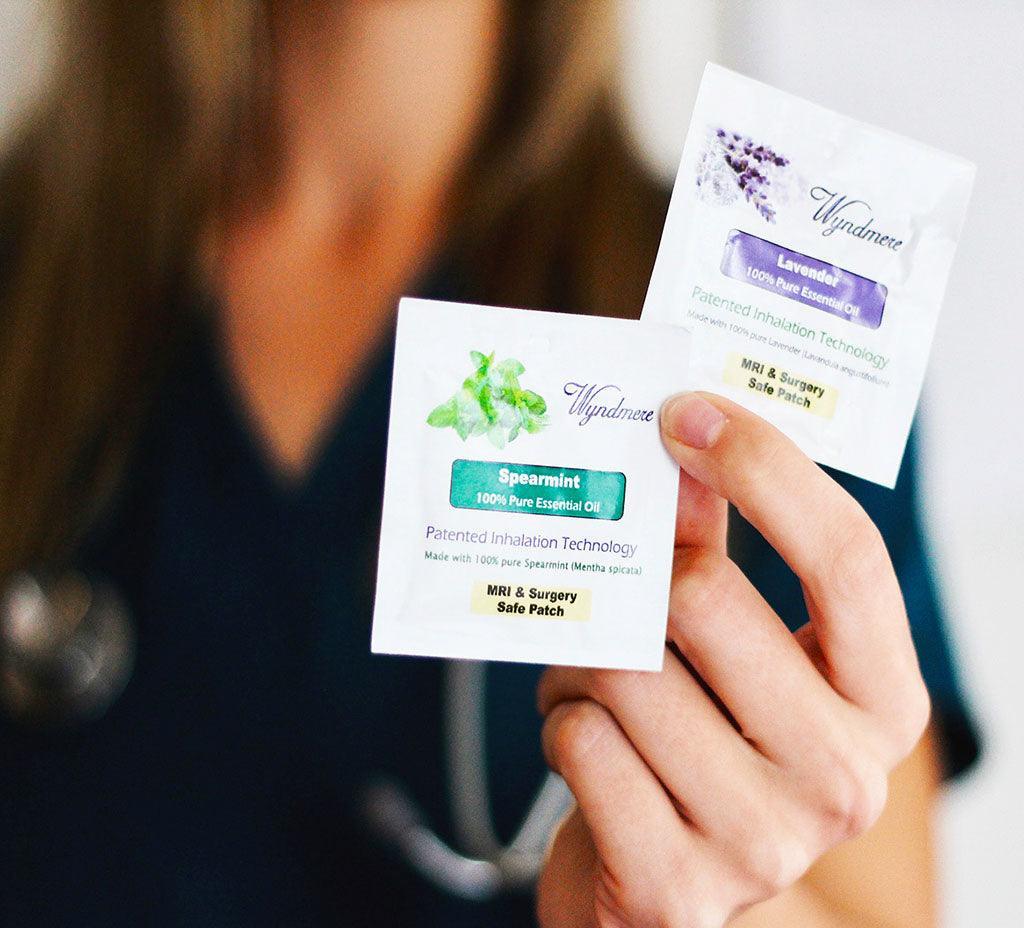 Nurse holding both a Lavender and a Spearmint MRI safe inhalation patch.