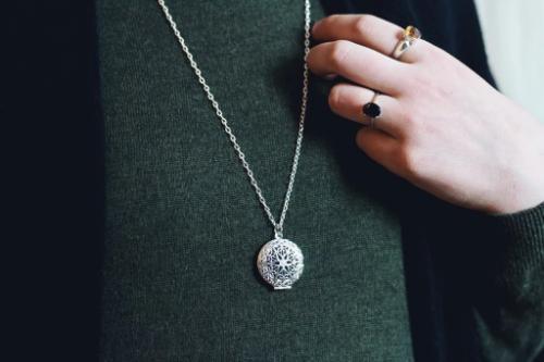 model wearing aromatherapy necklace with silver pendant on a silver chain