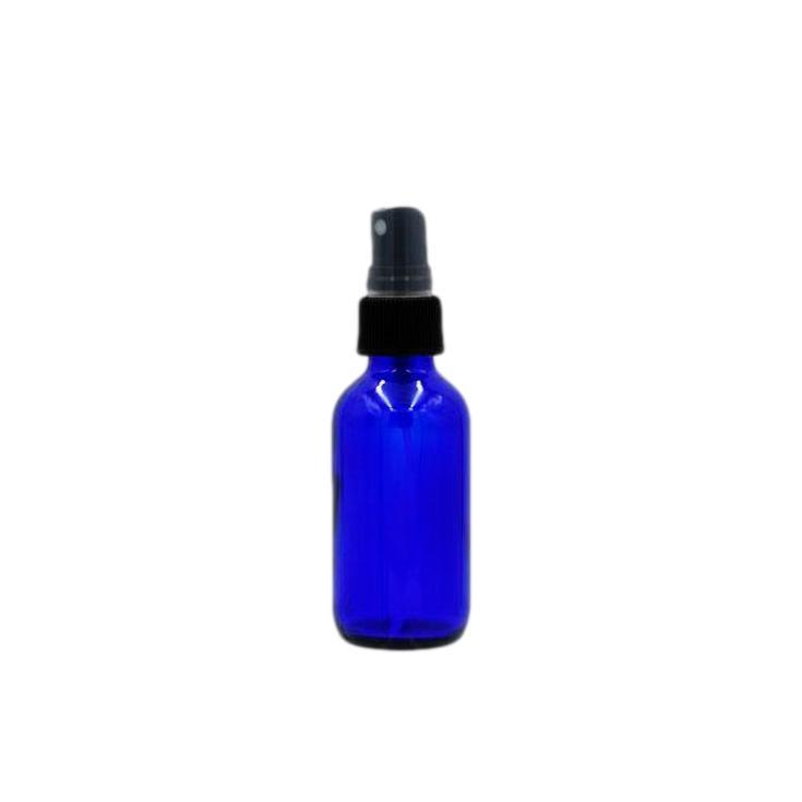 Empty cobalt blue glass bottle with fine mist sprayer