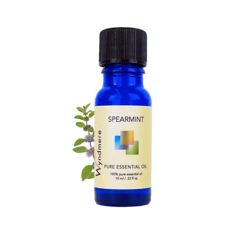 Spearmint flower top with a 10ml cobalt blue bottle of Wyndmere Spearmint Essential Oil