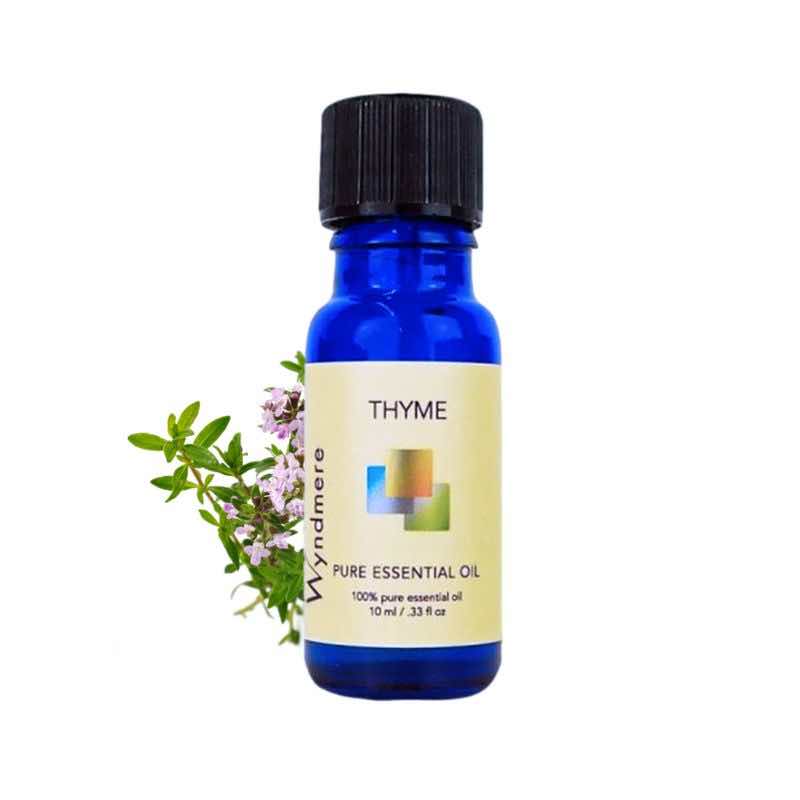 Thyme flowering top with a 10ml cobalt blue bottle of Wyndmere Thyme Essential Oil that has an intense herbal aroma