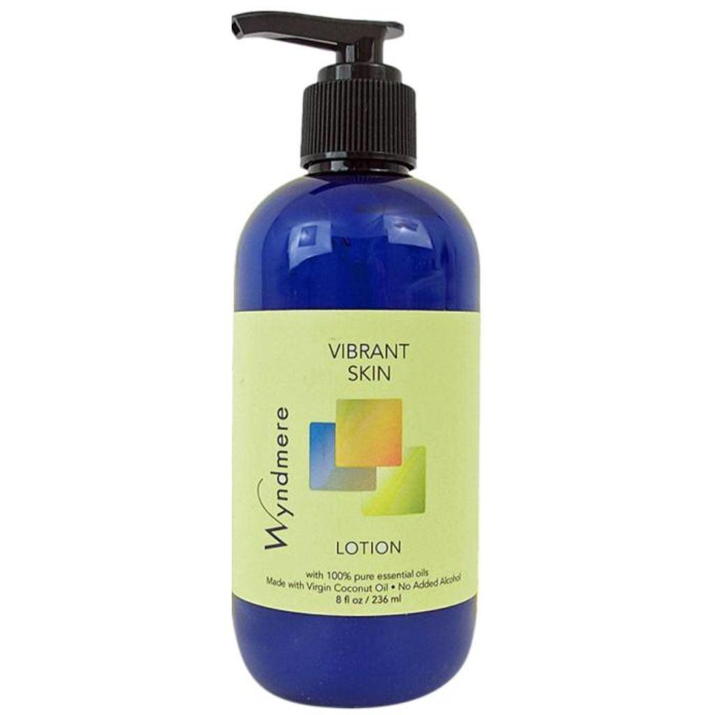 An 8oz cobalt blue bottle of Vibrant Skin Lotion using the best essential oils to help mitigate the effects of time