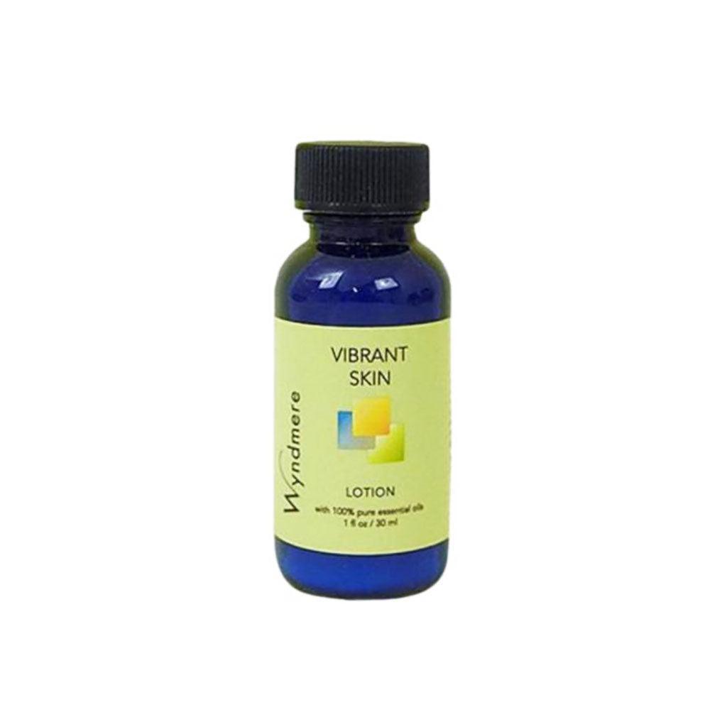 1oz cobalt blue bottle of Vibrant Skin Lotion using the best essential oils to help mitigate the effects of time